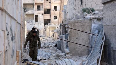 Syrian pro-government forces inspect an area of eastern Aleppo's Masaken Hanano district on November 27, 2016. George Ourfalian/AFP