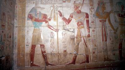 Painted relief of Sethos before Anubis (jackal headed god), Temple of Sethos I, Abydos, Egypt, 19th Dynasty, c1280 BC. Getty Images