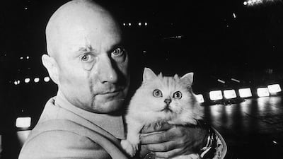 Ernst Stavro Blofeld, James Bond's arch nemesis, played by Donald Pleasence, holding a white cat on the set of 'You Only Live Twice' in 1966. (Photo by Express Newspapers/Hulton Archive/Getty Images)