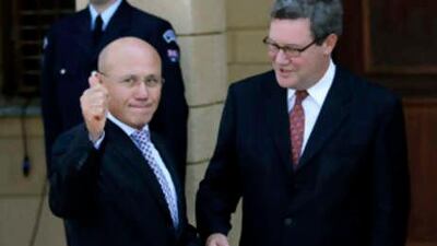 Turkish Cypriot leader Mehmet Ali Talat gestures to the media as UN special envoy for Cyprus, Alexander Downer, looks on before a meeting with Cypriot President Dimitris Christofias.