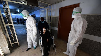 Members of the medical team spray disinfectant as a precaution against the novel coronavirus outbreak at the Al Kindi hospital in Baghdad, Iraq on March 5, 2020. EPA