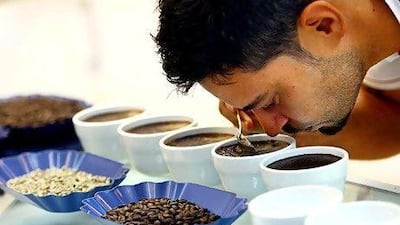 Roastmaster Rosco Franklin smells the coffee at Coffee Planet in Dubai. (Satish Kumar / The National )