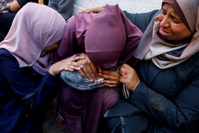 A mother mourns her son, who was killed by Israeli fire while trying to receive aid. Reuters