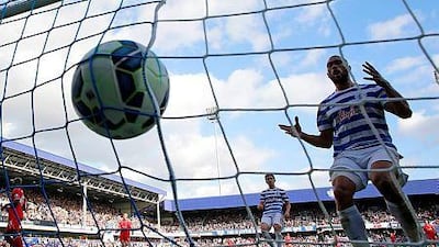 Queens Park Rangers defender Steven Caulker, right, reacts to scoring his own-goal during the English Premier League football match against Liverpool at Loftus Road in London on October 19, 2014. Liverpool won the game 3-2. AFP PHOTO / ADRIAN DENNIS