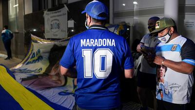 Supporters of Diego Maradona gather outside the hospital where he undergoes a brain surgery for a blood clot, in Olivos, Buenos Aires. AFP