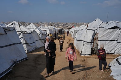 A Palestinian woman and child in a tented community for the displaced in Gaza city on December 17, 2025. AP Photo