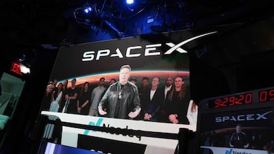 Elon Musk, founder and chief executive of SpaceX, speaks via video link before the ringing of opening bell at the Nasdaq stock exchange. AFP