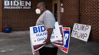Tony Hickson holds signs in support of Joe Biden in Youngstown, Ohio, on September 22, 2020. Ohio has been a political prize for generations of candidates wooing the state's diverse voting demographic, which closely mirrors the nation and has offered a reliable gauge of American sentiment. AFP