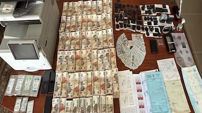Cash and forged documents were seized from suspected fraudsters. Photo: Egypt's Administrative Control Authority