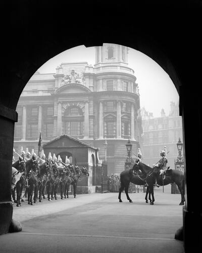Mounted horse guards are seen outside the Old War Office in the 1930s. Getty