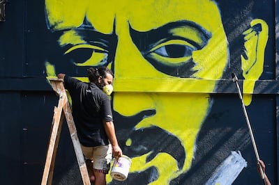 Artists work on a mural of late Bollywood actor Irrfan Khan on a wall in a neighbourhood in Mumbai. The acclaimed actor died last week at the age of 53. AFP