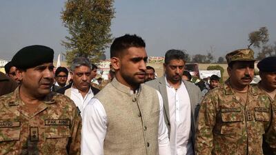 Boxer Amir Khan arrives on Monday at the army-run school where the Taliban massacred 148 people on December 16. A Majeed / AFP