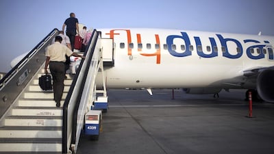 Passengers board a flydubai flight. Low-cost airlines offer an alternative for UAE travellers. Galen Clarke / The National