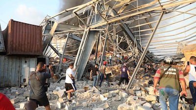 People walk at scene of the explosion in Beirut. AFP