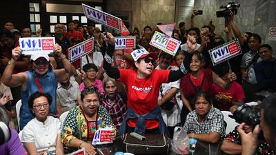 Supporters of the Pheu Thai party react at the party's headquarters in Bangkok. AFP
