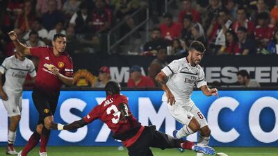 AC Milan's Patrick Cutrone fights for the ball with Manchester United's Eric Bailly. AFP