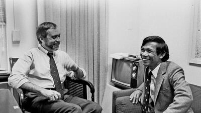 In this Jan. 15, 1980 photo, Sydney Schanberg, left, talks with his Cambodian assistant Dith Pran at the New York Times office in New York. Schanberg, the Pulitzer Prize-winning correspondent for The New York Times, whose coverage in Cambodia in 1975 inspired the film "The Killing Fields," has on July 9, 2016 at the age of 82. The New York Times via AP