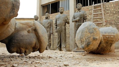 Statues of topped dictator Saddam Hussein in a factory, in Baghdad, Iraq, in 2003. EPA
