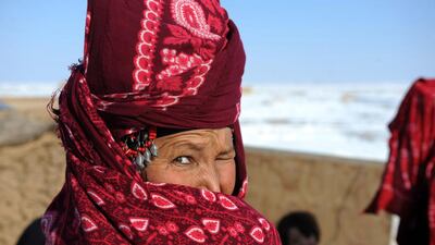 An Afghan internally displaced woman covers her face in Sakhi camp in Mazar-i-Sharif on February 10, 2014. Taliban fighting in southern Afghanistan forced many families to flee their homes and spend the harsh winter season at the camp in poverty. Farshad Usyan / AFP photo