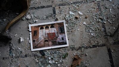 A photo rests among broken glass on the floor of the Sursock Palace. AP Photo