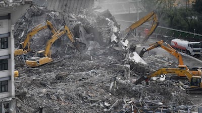Excavators clear rubble during demolition of the Workers' Stadium. AFP