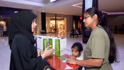 Alia Belgaizi, left, a volunteer with the Dubai Foundation for Women and Children, talks to Priya Srinivas, with her daughter Stuthi, as part of the abuse awareness campaign at the Dubai Mall on Wednesday.