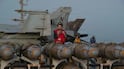 US sailors on the flight deck of USS Abraham Lincoln in the Arabian Sea. AFP