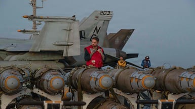 US sailors on the flight deck of USS Abraham Lincoln in the Arabian Sea. AFP