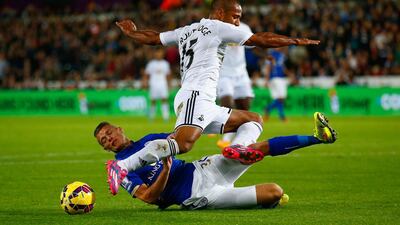 Paul Konchesky of Leicester City tackles Wayne Routledge of Swansea City during their Premier League match on Saturday in Swansea. Clive Rose / Getty Images