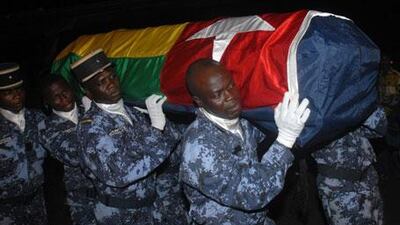 Togolese gendarmes carry a coffin wrapped in the national flag of one of the victims of an on the Togolese national football team on January 8, 2010.