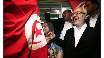 Rached Ghannouchi (R), leader of the Islamist Ennahda movement in Tunisia, smiles as he meets his supporters after the announcement of the country's election results Thursday. The party won 90 seats in the 217-seat assembly.