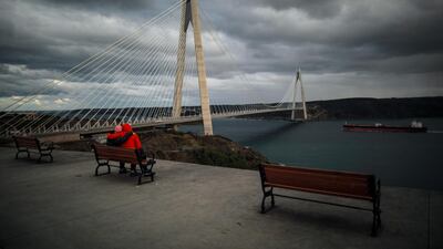 People enjoy the view next to the Yavuz Sultan Selim Bridge over the Bosphorus Strait in Istanbul. AP Photo