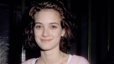 Winona Ryder in a blush pink long-sleeved shirt for an after-event party at 31st Grammy Awards on February 22, 1989. Getty