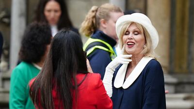 Dame Joanna Lumley poses for a photograph as she arrives for the coronation. PA