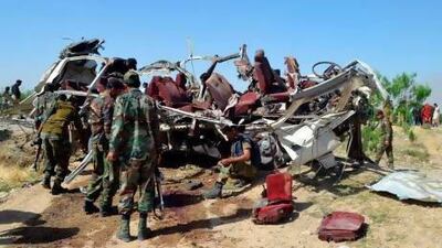 Pakistani police examine the destroyed vehicle used by police following a bomb attack on the outskirts of Quetta.