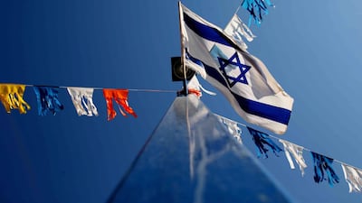 An Isreali flag flies. The National