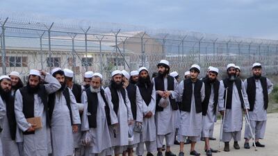 Newly freed Taliban prisoners line up at Bagram prison in Afghanistan on April 11, 2020. The insurgent group says the government's prisoner release is not according to the terms agreed with United States. National Security Council of Afghanistan via Reuters