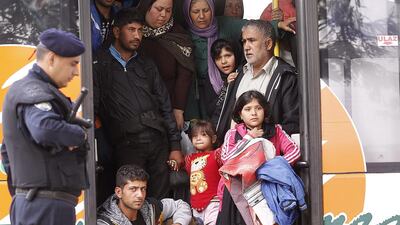 Refugees wait in a bus, which will transfer them to Hungary from the town of Tovarnik in Croatia on September 25, 2015. Antonio Bat/EPA