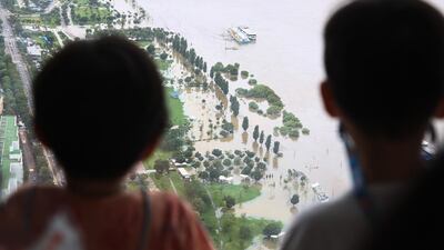Children look at the Han River overflowing from the 63 Building in Seoul, South Korea. EPA