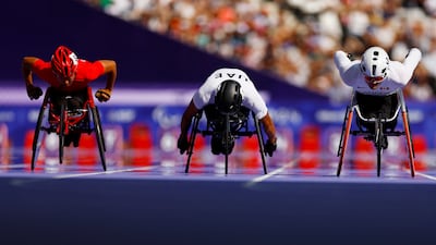 Mohammed Othman, centre, was the UAE's breakout star in Paris, placing fifth in the T34 100m. Reuters