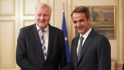 Kyriakos Mitsotakis (right) met with German interior minister Horst Seehofer in Athens on Friday. EPA