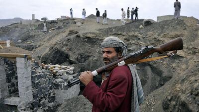A member of the Shiite rebel militias stands guard at the Al-Iman Sunni Islamic University which they seized control of it in Sanaa, Yemen. Yahya Arhab / EPA