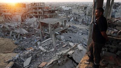 A Palestinian man in the ruins of his house looks out over what is left of his neighbourhood in the eastern districts of Gaza City that witnesses said was destroyed during the Israeli offensive. Suhaib Salem / Reuters
