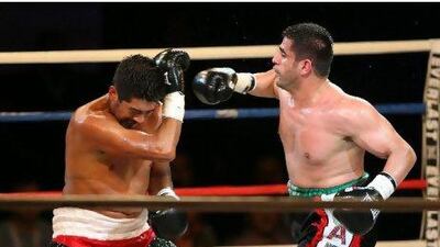 DUBAI , UNITED ARAB EMIRATES - Feb 2 : Eisa Aldah ( UAE right ) and Miguel Angel Munguia ( Mexico left ) during the Dubai International Boxing Championship held at the Aviation Club in Dubai. Eisa won the fight. ( Pawan Singh / The National ) For Sports. Story by Gary Meenaghan