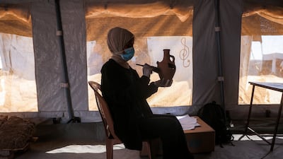 Restoration work on cultural artefacts collected during the war in Gaza is carried out in a tent in Khan Younis, southern Gaza. AFP