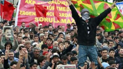 Demonstrators make V-signs as they display Kurdish tricolours and a picture of the jailed Kurdish rebel leader Abdullah Ocalan during a rally in Istanbul to call public attention to the Ergenekon case in Istanbul.