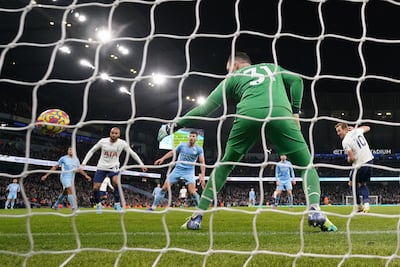 Harry Kane of Tottenham scores the winning goal past Manchester City goalkeeper Ederson. AP