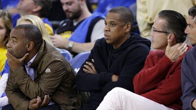 Recording artist Jay-Z watches the NBA basketball game between the Golden State Warriors and San Antonio Spurs on Monday night. Marcio Jose Sanchez / AP