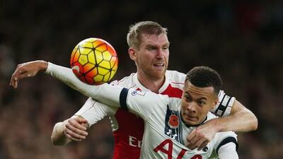 Tottenham's Dele Alli, right, vies against Arsenal's Per Mertesacker during a Premier League match. Reuters / Eddie Keogh