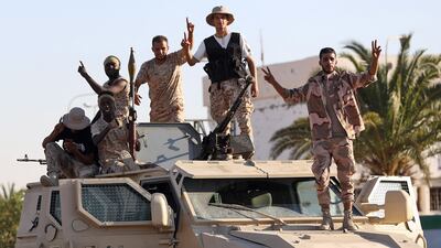 Joint forces affiliated with Libya's Government of National Unity assemble inside the closed Tripoli International Airport, as they deploy on the outskirts and entrances of the capital Tripoli on July 25, 2022. - At least 16 people were killed and 52 wounded in fighting between armed groups in Tripoli, the health ministry said on July 23, following the latest politically driven violence to hit the Libyan capital. (Photo by Mahmud Turkia / AFP)